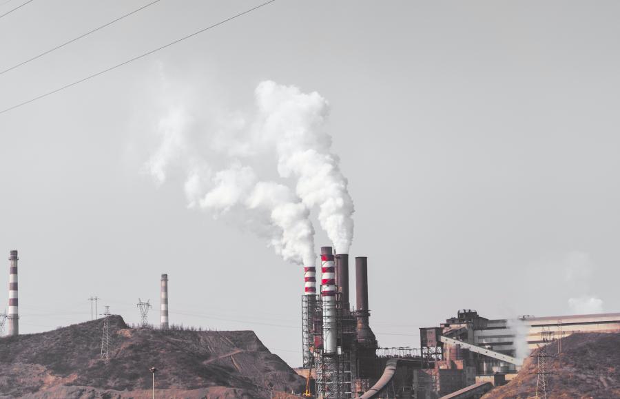 Smoke comes out from industrial factory chimney.